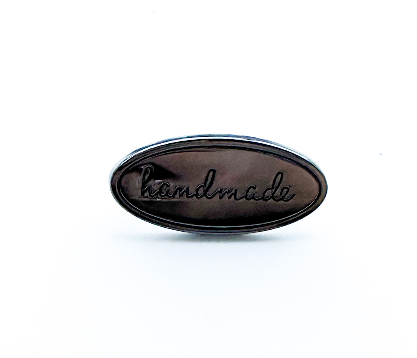 “Handmade” metal oval bag label