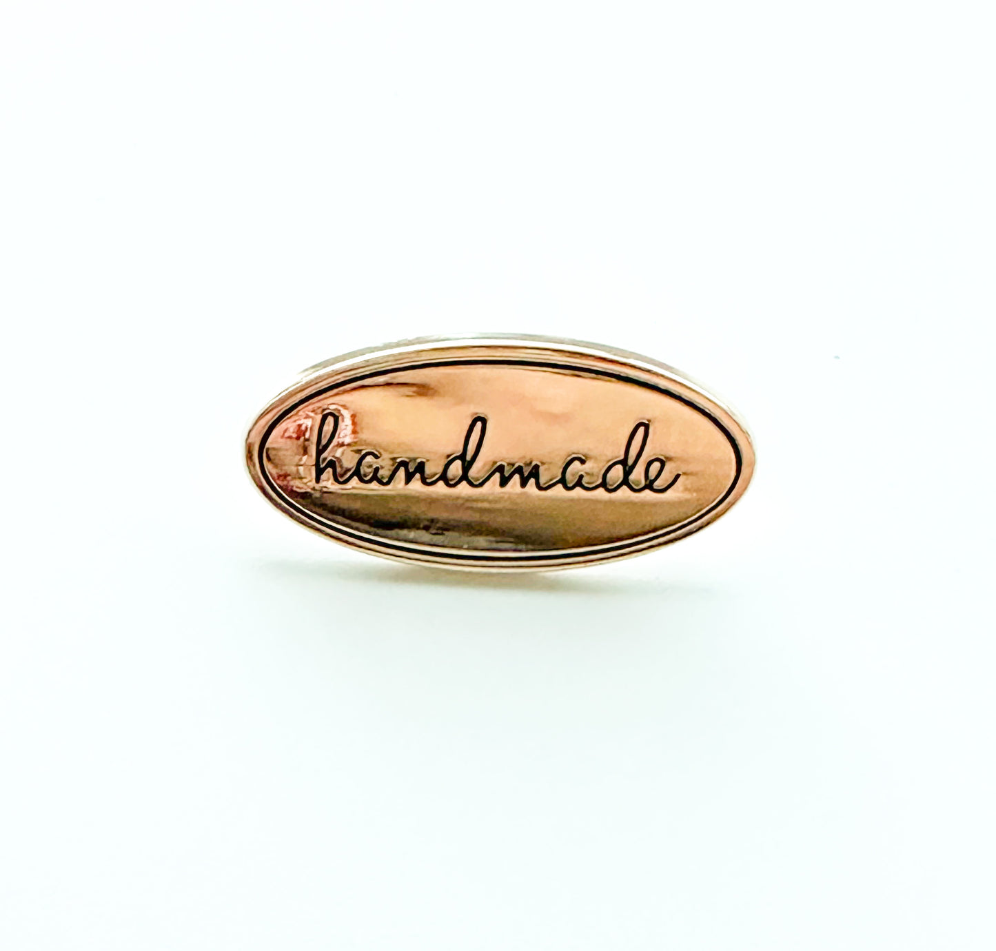 “Handmade” metal oval bag label