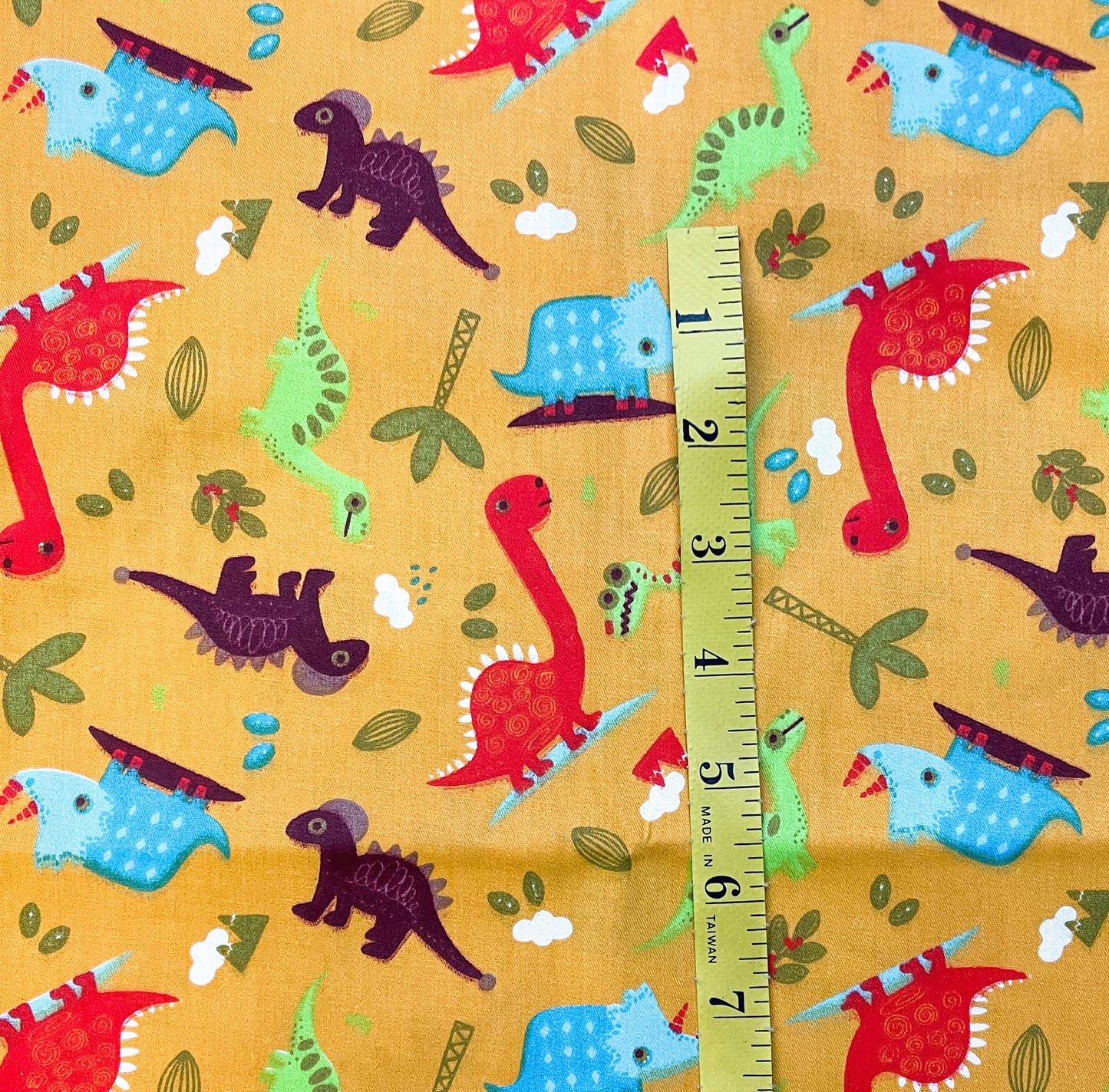 Dinos and trees on yellow 24” end cut