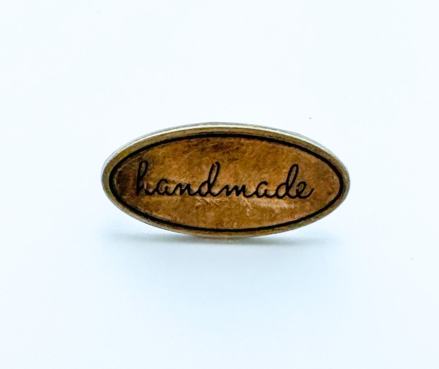 “Handmade” metal oval bag label